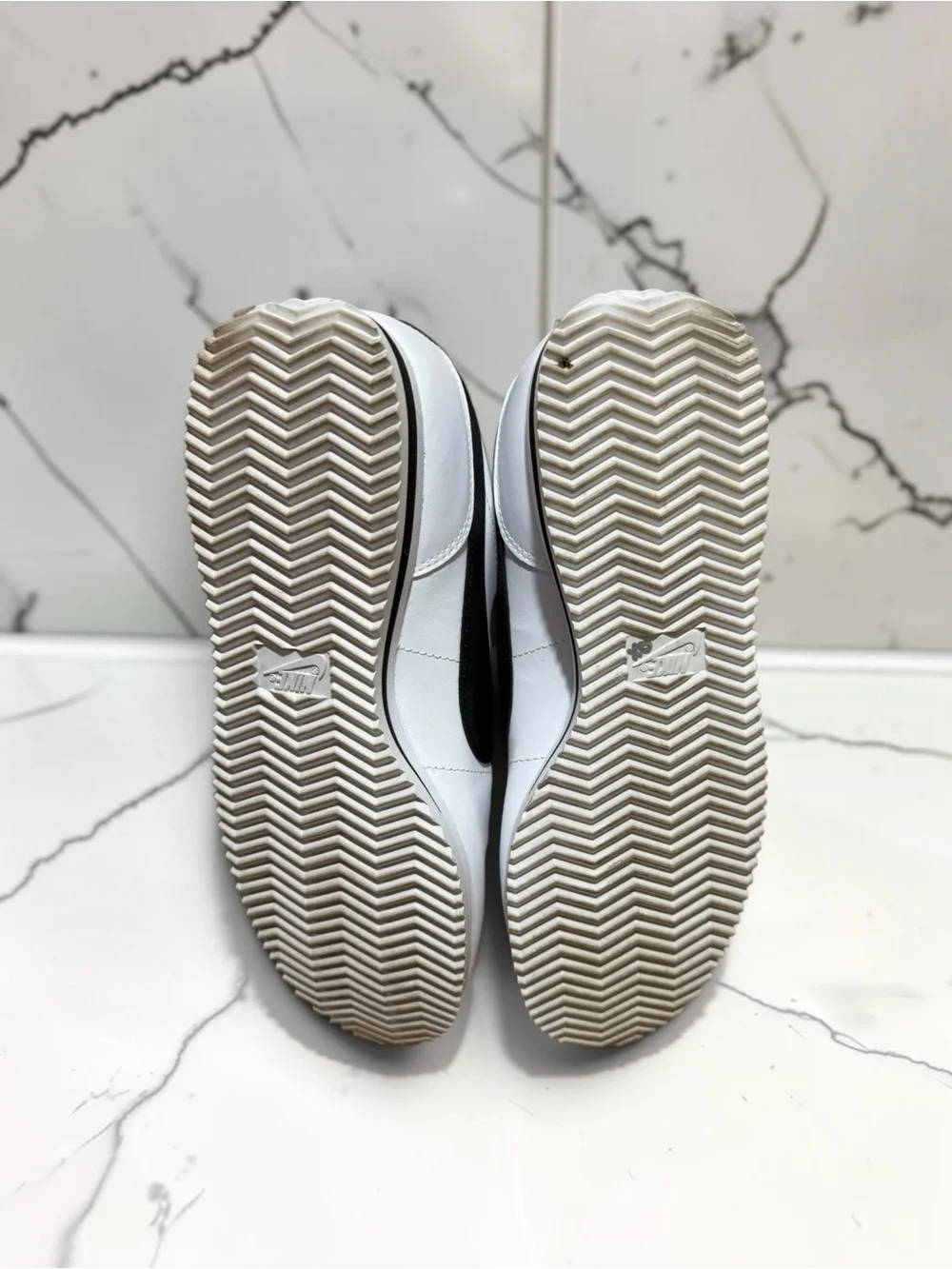 Nike Men’s White Leather Sneakers with Black Swoosh